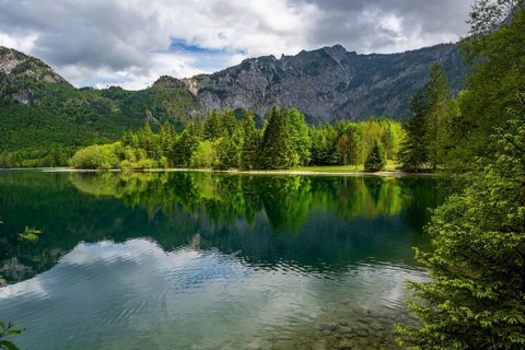 Landscape of Lake Offensee after rain when the sun comes through the clouds in spring,