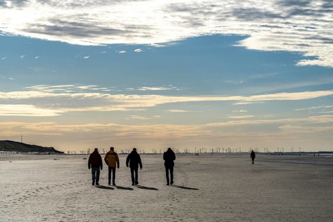 Walkers on the Wadden Sea near the East Frisian island of Spiekeroog, west of the North Sea island,