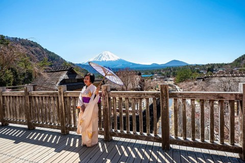Japanese woman in kimono with umbrella, Iyashinosato open-air museum, old Japanese village with