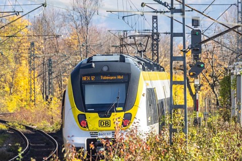 Local train on an open route in the area of Stuttgart North Station. Arched bridge and landscape in