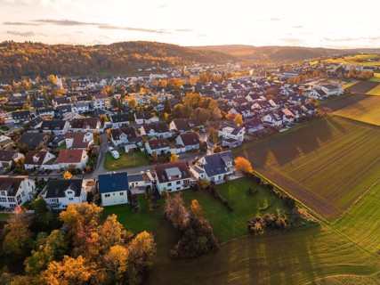 Settlement and fields in evening light, autumn hills with colorful trees, Aidlingen, Böblingen