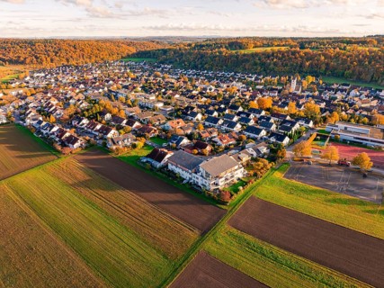 Large-scale view of a village bordering fields, in warm autumn light, Aidlingen, Böblingen