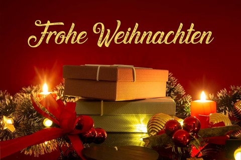 Christmas greetings: table with Christmas decoration and gifts against a red background with