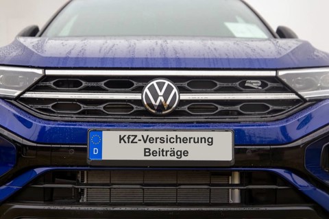 (photo montage) Close-up of a license plate with text Car insurance CONTRIBUTIONS