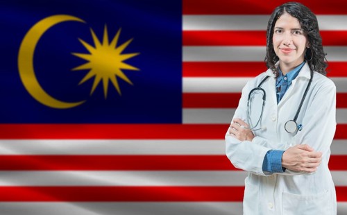 Malaysian medicine and healthcare concept. Close up of doctor against Malaysia flag background
