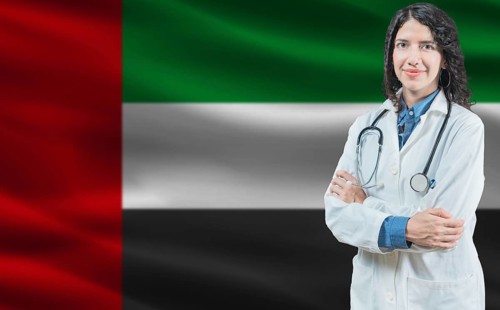 Emirati medicine and healthcare concept. Close up of doctor against United Arab Emirates flag