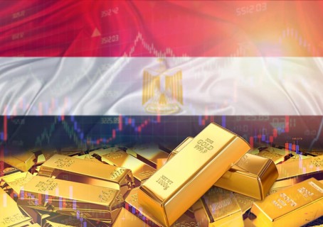 Gold bars on Egypt flag in background. Gold bars stacked on Egyptian flag. Concept of Egypt gold