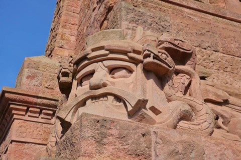 Warrior's face with snake figure and dragon at the Kyffhäuser monument, detail, figure, stone, red,