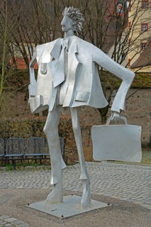 Sculpture man with suitcase by Kurt Laurenz Metzler 2007, sculpture mile, male figure, tin,