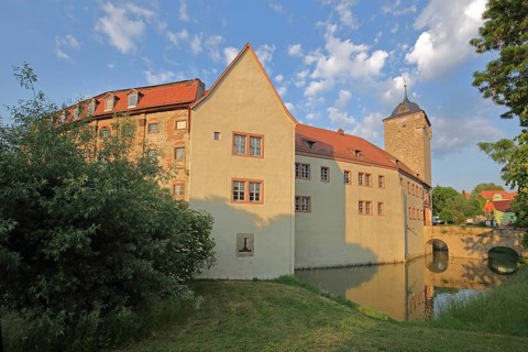 Moated castle built 12th century with tower, arched bridge with pond, medieval Kapellendorf,