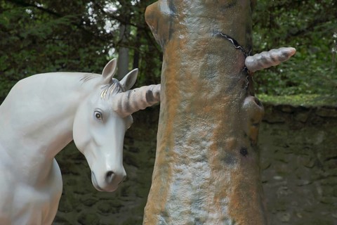 Horn of a unicorn in fairy tale The brave little tailor forcefully pierces a tree trunk, sculpture,