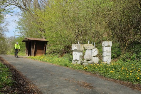 Aartalradweg with Yolo sculpture by G. von Rosenthal, cycle path, cyclist, refuge, inscription,