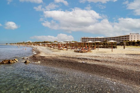 Parasol, sun lounger, sea, pebble beach, piled up with sand, people on the beach, Hotel Mitsis