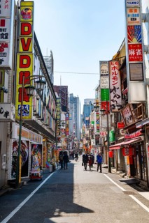 Street scene, lots of colorful signs of shops, restaurants and bars in a street, Shinjuku City,