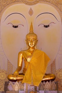 Golden Buddha statue with tunic, Bhumispara mudra, Buddha Gautama at the moment of enlightenment,