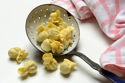 Saccottini, type of Italian pasta in a sieve ladle, pasta from Italy