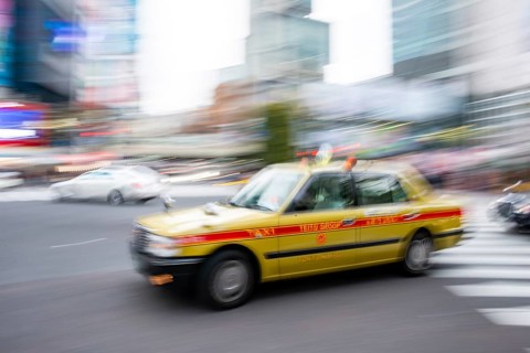 Elderly yellow taxi driving, motion blur, long exposure, Shubuya Crossing, Shibuya, Tokyo, Japan