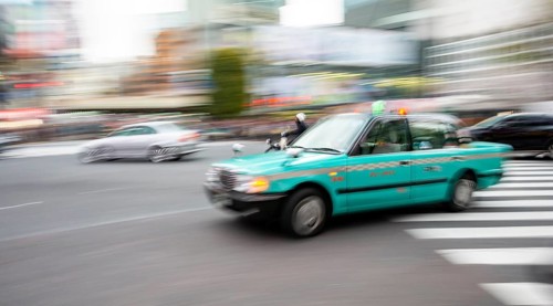 Elderly turquoise taxi driving, motion blur, long exposure, Shubuya Crossing, Shibuya, Tokyo, Japan