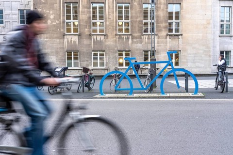 Bicycle parking spaces, with so-called leaning bars and a large blue bicycle silhouette, to make