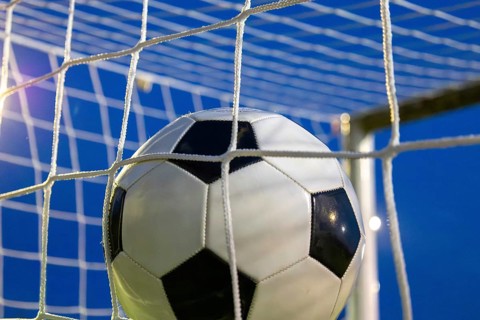 Soccer symbol: close-up of a soccer ball under floodlights