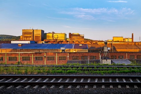Deutsche Edelstahlwerke with train tracks at sunrise, central railway station, Witten, Ruhr region,