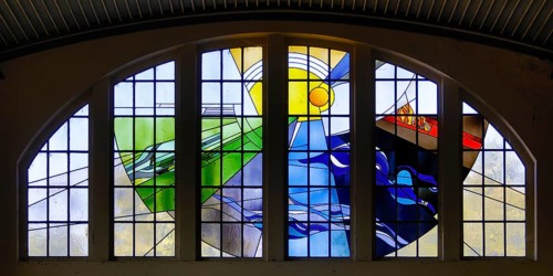 Lead glazing of the windows above the main entrance with the title Four Elements by Horst
