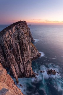 Totem Pole and The Lanterns. Long exposure at sunrise shows glowing dawn over the dramatic cliffs
