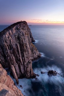 Totem Pole Long exposure at sunrise shows glowing dawn over the dramatic cliffs of Cape Hauy. Waves