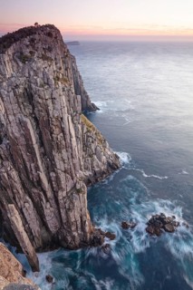 The Lanterns and Totem Pole Long exposure at sunrise shows glowing dawn over the dramatic cliffs of