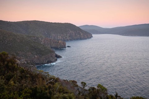 The Monument. Long exposure at sunrise shows glowing dawn over the dramatic cliffs of Cape Hauy.