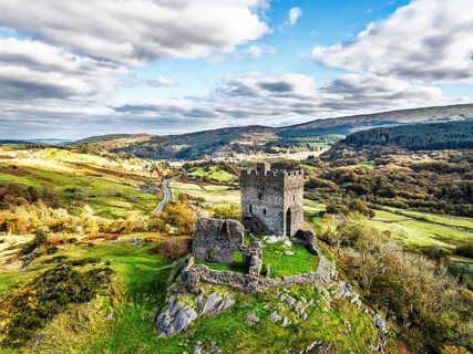 Autumn colours over Castell Dolwyddelan and Eryri Mountains from a drone, Snowdonia, Conwy County
