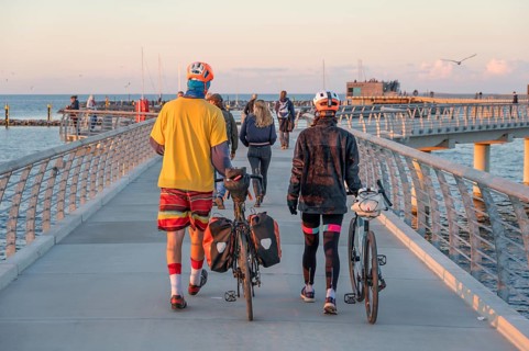 Tourists on the new 720-meter long pier in Prerow in the evening light, open since October 2024,