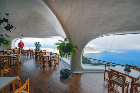 Interior of café with panoramic window in building designed by Cesar Manrique with the