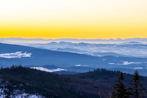 View from Mount Lusen over the hills of the bavarian forest at sunrise in winter, Bavaria, Germany