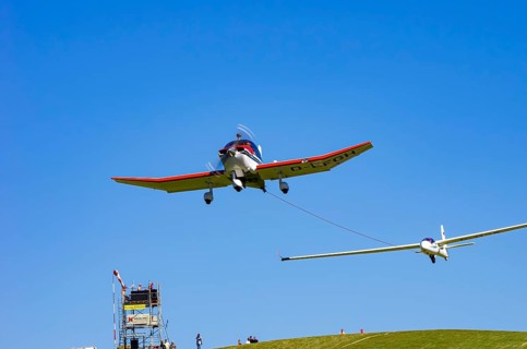 A Robin DR 400/200R Remorqueur light aircraft, registration D-EFGH, tows a glider during a flight