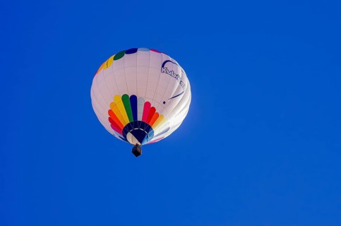 A hot air balloon, registration D-OÖJ, rises into the air as part of an air show at the