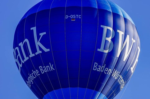 A hot air balloon, registration D-OSTC, rises into the air as part of an air show at the Rossfeld