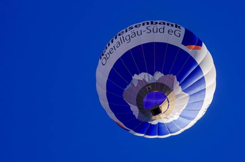 A hot air balloon, registration D-OASF, rises into the air as part of an air show at the
