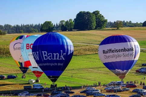 Hot air balloons are being prepared for takeoff as part of an air show at the Fliegerbergfest of