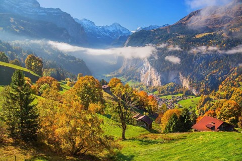 View from the village of the Lauterbrunnen Valley with Staubbach waterfall in autumn with morning