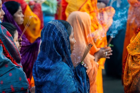 Hindu devotees gather on the banks of the Brahmaputra River to offer prayers to the Sun God on the