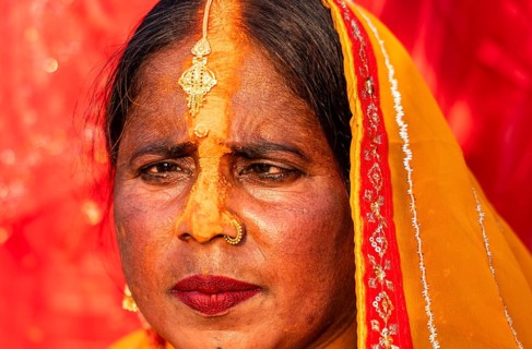 A Hindu devotee offer prayers to the Sun God on the bank of Brahmaputra river on the occasion of