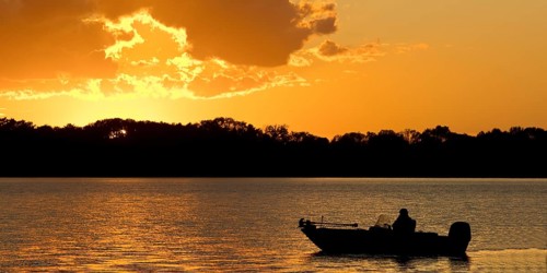 A boat on Lake Gudelack at sunset, Lindow (Mark), Stechlin-Ruppiner Land nature park Park,