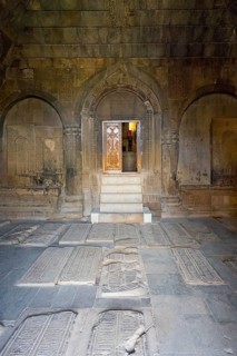 Stone burial chamber with carved tombstones and door to the interior, Noravank Monastery, Surb