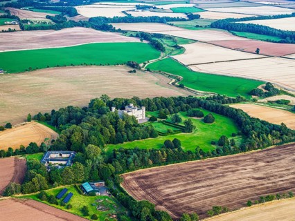 Wedderburn Castle and Barns over fields from a drone, Duns, Berwickshire, Scotland, UK