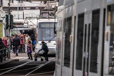 Pedestrians cross the tram tracks, at Düsseldorf-Bilk station, junction of S-Bahn, subway, tram,
