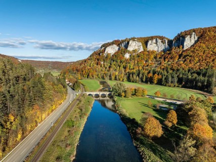Aerial view of the Upper Danube Valley surrounded by autumn vegetation with the Hausender Peaks