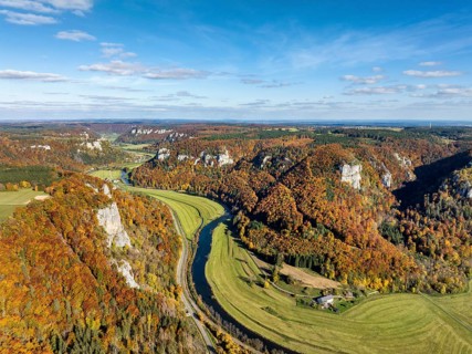 Aerial view of Upper Danube Valley surrounded by autumn vegetation, on the horizon Werenwag Castle,