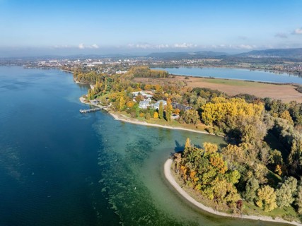 Aerial view of the Mettnau peninsula, surrounded by autumn vegetation, in western Lake Constance