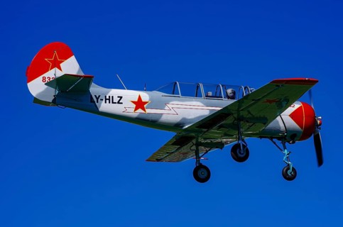 A Jakovlev Jak-52 with registration LY-HLZ during a flight demonstration as part of an air show on